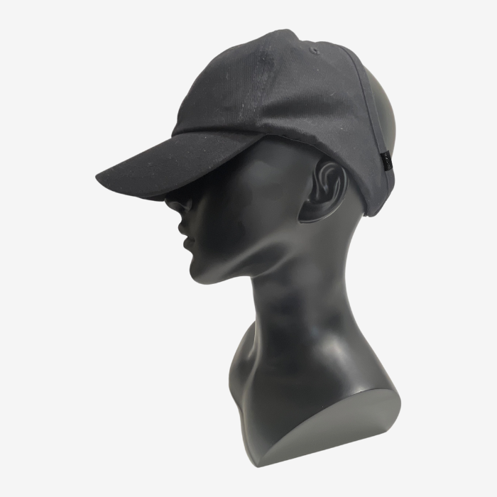 Black baseball cap on a mannequin head against a white background