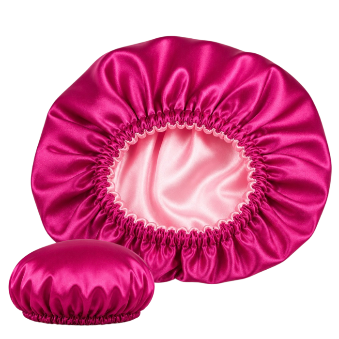 Fuchsia satin sleep bonnet with soft pink interior for overnight hair protection and moisture retention.
