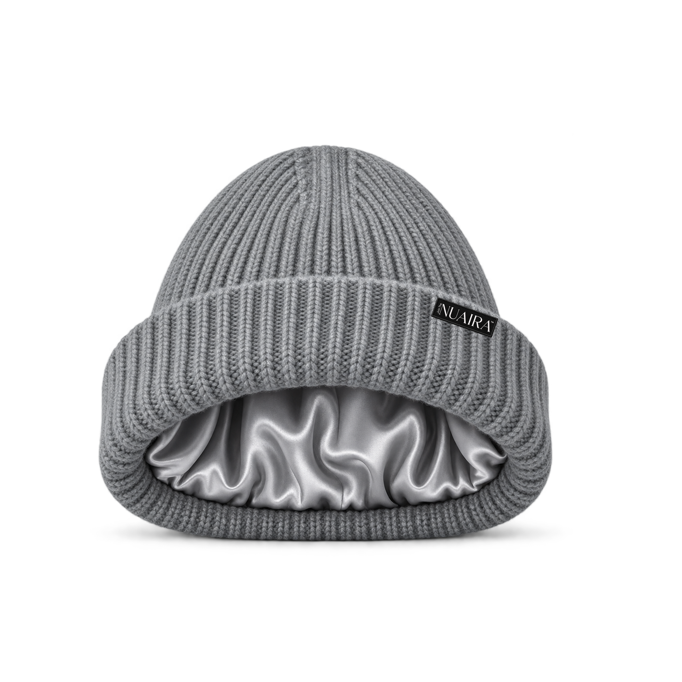 Grey black ribbed knit beanie hat with a shiny grey satin inner lining, shown on a white background with a grey NUAIRA brand tag in the lower left corner.