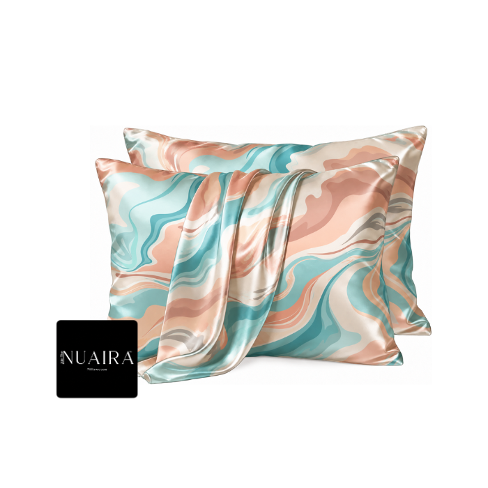 Two square satin pillowcases with a marbled swirl pattern in teal, peach, beige, and gray, by Nuaira brand 