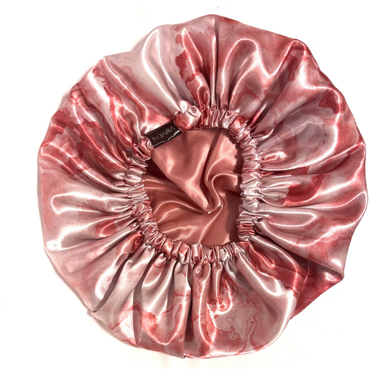 Indulge in the opulence of a pink marble satin bonnet for the ultimate beauty sleep.