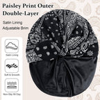Black paisley satin-lined turban headwrap for women featuring a luxurious paisley pattern and smooth satin lining that helps retain moisture, reduce friction, and protect natural hair, braids, locs, and curls. Featuring adjustable brim.
