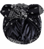 Black paisley satin-lined turban headwrap for women featuring a luxurious paisley pattern and smooth satin lining that helps retain moisture, reduce friction, and protect natural hair, braids, locs, and curls.