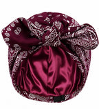 Burgundy paisley satin-lined turban headwrap for women featuring a luxurious paisley pattern and smooth satin lining that helps retain moisture, reduce friction, and protect natural hair, braids, locs, and curls.