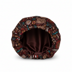 NuAira Enola tribal satin fabric swatch – dark brown African symbol print for cultural hair bonnet