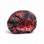 NuAira Nubian Bloom satin fabric swatch – coral and teal Ankara geometric print for hair bonnet