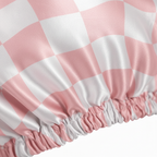 Close-up of NuAira blush pink abstract checker satin bonnet – silky double-layer texture for frizz protection